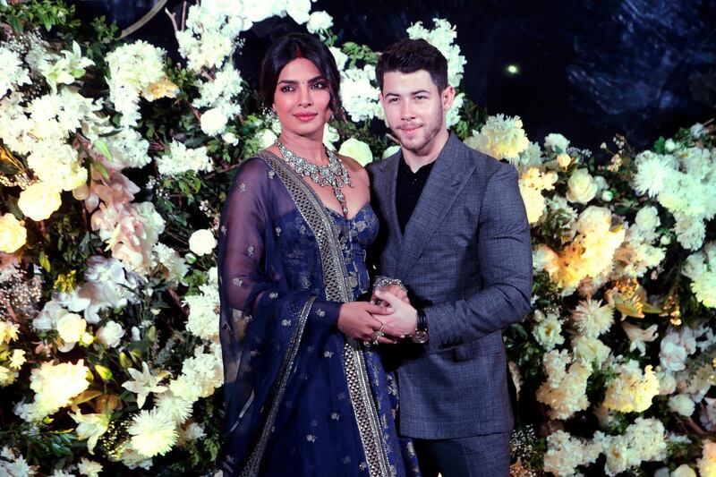 Priyanka wore a navy lehenga while Jonas wore a grey suit  (AP Photo/Rajanish Kakade)