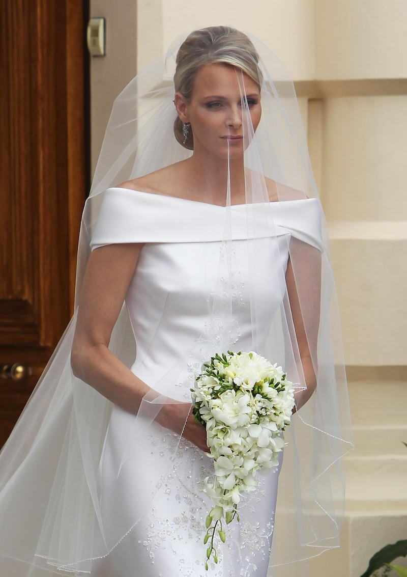 MONACO - JULY 02: Princess Charlene of Monaco attends her religious ceremony of the Royal Wedding to husband Prince Albert II of Monaco in the main courtyard at the Prince's Palace on July 2, 2011 in Monaco. The Roman-Catholic ceremony follows the civil wedding which was held in the Throne Room of the Prince's Palace of Monaco on July 1. With her marriage to the head of state of the Principality of Monaco, Charlene Wittstock has become Princess consort of Monaco and gains the title, Princess Charlene of Monaco. Celebrations including concerts and firework displays are being held across several days, attended by a guest list of global celebrities and heads of state.  (Photo by Dan Kitwood/Getty Images) 