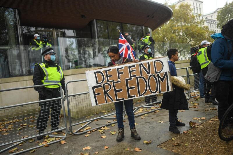 A protester holds a sign reading 'Defend Freedom' during a Unite for Freedom march outside New Scotland Yard in London. Getty Images