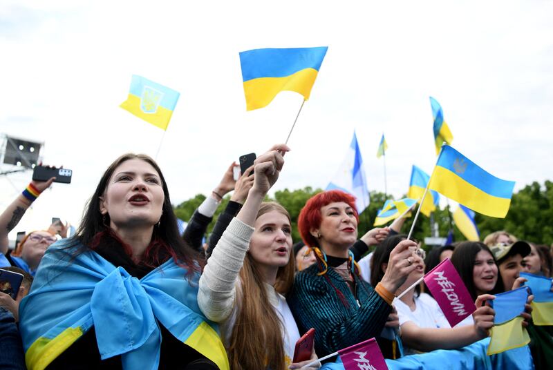 Demonstrators hold Ukrainian flags at a charity telethon in support of Ukraine, in Berlin. Reuters