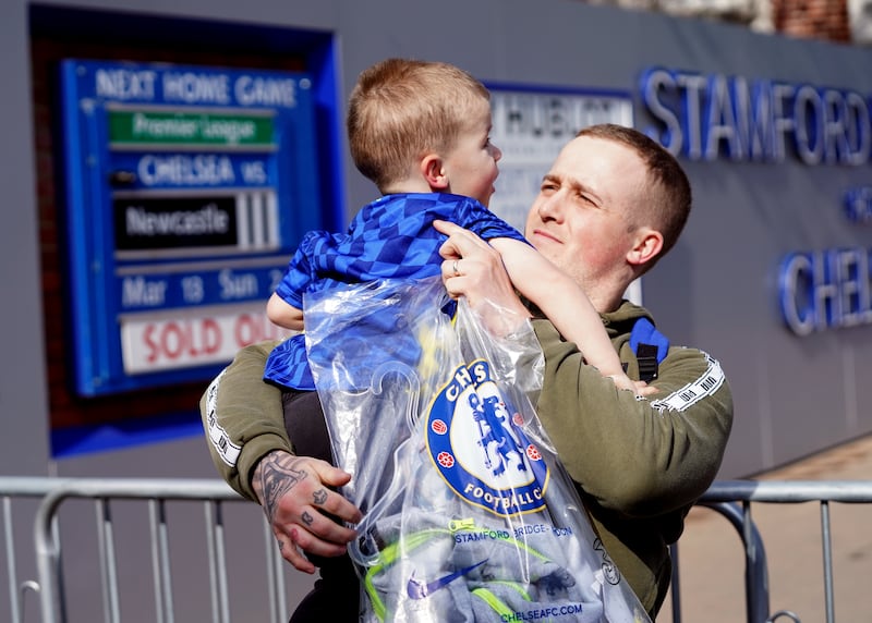 Martyn Hardiman with his son Peter, 2, after purchasing the last club shirt before the store closed. PA