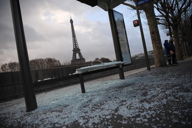 A broken bus stop with the Eiffel tower in the background after Yellow Jacket protests in Paris.  AFP