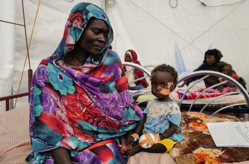 A Sudanese woman sits beside her daughter who is suffering from malnutrition at a Medecins Sans Frontieres mission hospital in Adre, Chad.