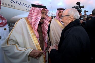 Saudi Arabia's King Salman is greeted by Tunisian President Beji Caid Essebsi at the Tunis-Carthage International Airport. Tunisian Presidency via AP