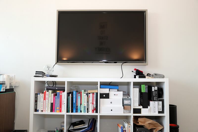 Alwaleed Osman's television and book stand in his apartment. Pawan Singh / The National