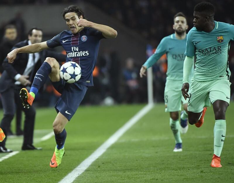 Paris Saint-Germain's Edinson Cavani vies with Barcelona's Samuel Umtiti. Lionel Bonaventure / AFP