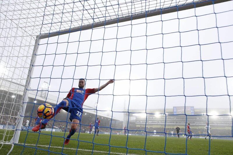 Crystal Palace’s Damien Delaney attempts to stop Diego Costa’s goal. Adrian Dennis / AFP