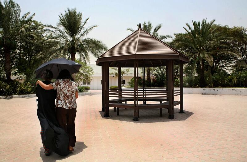 A social worker and a ward of the Dubai Foundation for Women and Children walk in the shelter’s courtyard in July 2008. There has been a 75 per cent decline in the number of human-trafficking victims. Nicole Hill / The National