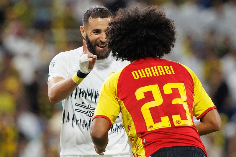 Ittihad's French forward Karim Benzema shares a joke with Esperance's Tunisian midfielder Ghaith Ouahabi. AFP