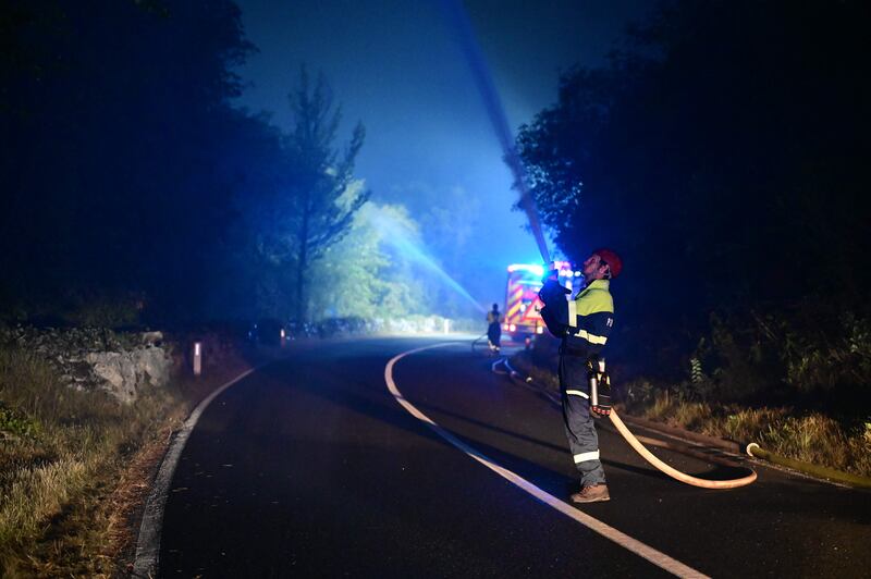 Firefighters tackle a blaze close to the village of Opatje Selo, western Slovenia.  AFP