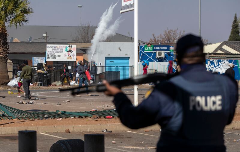 People throw stones at police in Katlehong.