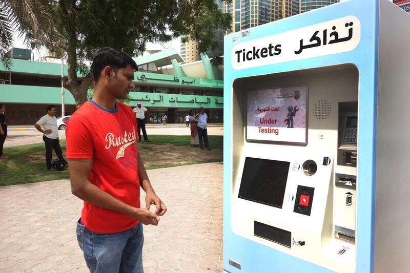 Vinojin Aruldas, 26, checks out the new ticket vending machine at the bus terminal in Abu Dhabi. DELORES JOHNSON / The National