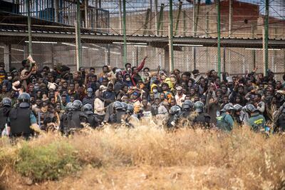 Dozens of migrants storm the border crossing between Morocco and Melilla. AP