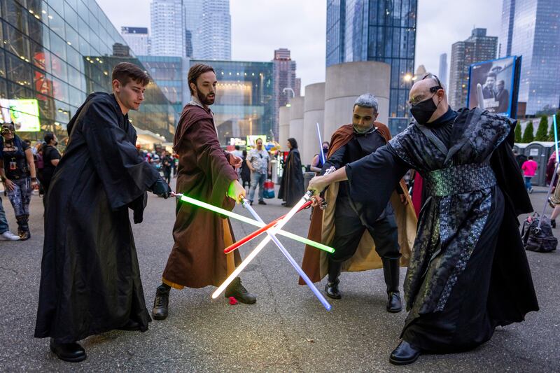 Attendees dressed as Jedi pose during New York Comic Con at the Jacob K.  Javits Convention Center on Saturday, Oct.  9, 2021, in New York.  (Photo by Charles Sykes / Invision / AP)