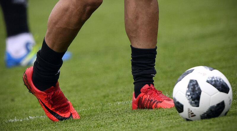 A picture taken on June 12, 2018 shows Nike football shoes of Iran's forward Mehdi Taromi during a training session in Bakovka, outside Moscow, ahead of the Russia 2018 World Cup football tournament. The American equipment manufacturer Nike confirmed on June 11, 2018 it had stopped supplying Iran's football team with boots ahead of the World Cup due to sanctions. A statement from Nike said the company was forbidden from supplying kit to the Iranian team as it prepares for its opening World Cup game. / AFP / Alexander NEMENOV
