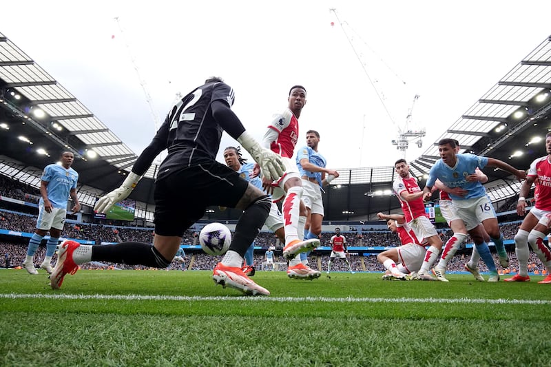 Arsenal's David Raya blocks an effort. Reuters