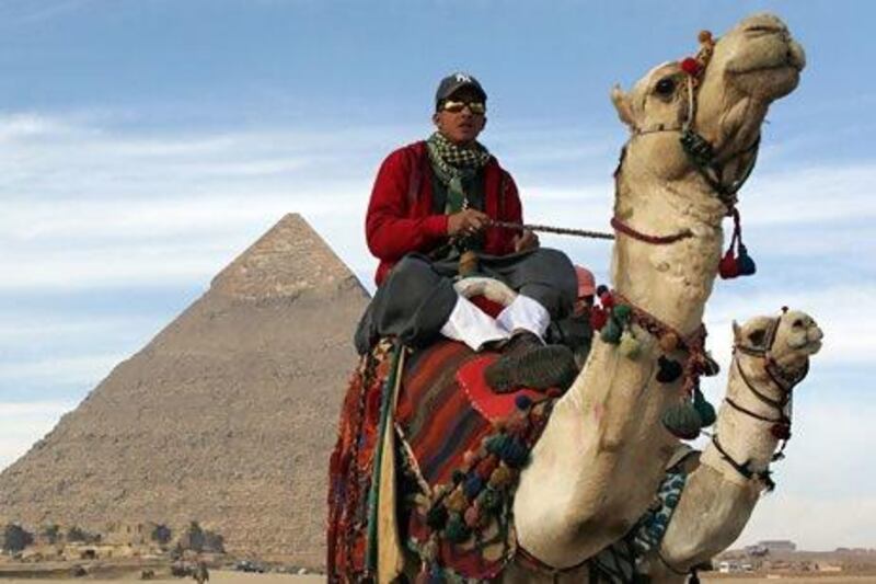 A tourist guide poised for business at Giza. In the first 11 months of last year, 10.5 million tourists visited Egypt. Asmaa Waguih / Reuters