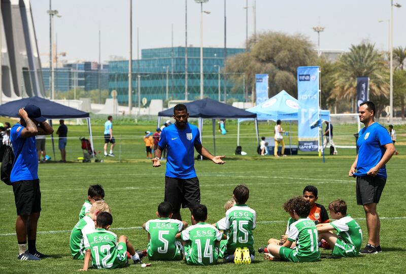 Abu Dhabi, United Arab Emirates - Juventus (white/black) vs. ESG Football Academy from Oman (green) under 12 age group on Abu Dhabi World Cup Day 1 at Zayed Sports City. Khushnum Bhandari for The National
