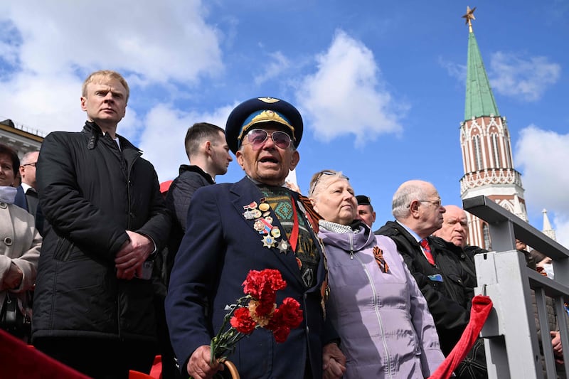 Veterans and guests watch the Victory Day military parade at Red Square in central Moscow. AFP