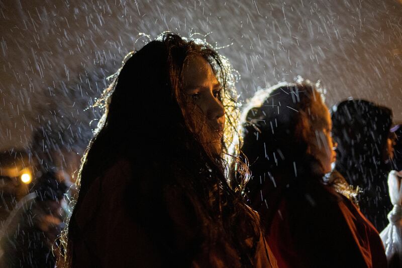 Sulma, 17, from Honduras, endures cold and wet weather while standing with other young migrants traveling without adults as they surrender to border patrol agents after being smuggled across the Rio Grande from Mexico into Texas. Reuters