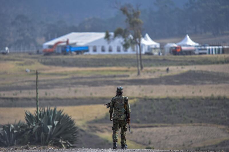 A security personnel patrols near near the crash site of flight ET302 for the commemoration of the first anniversary in Tulu Fara, Ethiopia. AFP