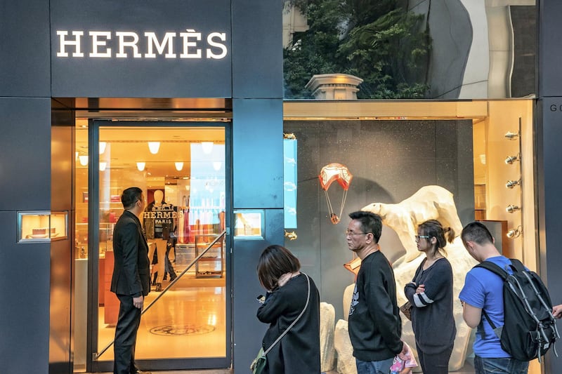 Shoppers wait in line outside a Hermes International SCA store on Canton Road in the Tsim Sha Tsui district of Hong Kong, China, on Sunday, Feb. 3, 2019. The week-long Lunar New Year holiday, starting Feb. 4, will provide the next litmus test of the resilience of the Chinese shopper. The seven-day period sees hundreds of millions of people travel within the country to see relatives, fly overseas to takevacations - and open their wallets to buy gifts. Photographer: Anthony Kwan/Bloomberg