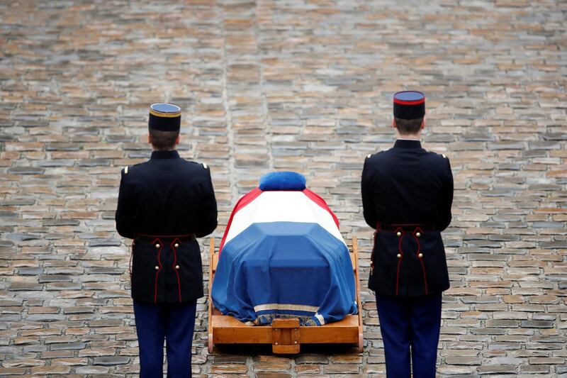 French Republican guards stand in front of the flag-draped coffin of late Gendarmerie officer Colonel Arnaud Beltrame, who was killed by an Islamist militant after taking the place of a female hostage during a supermarket siege in Trebes, during a national ceremony at the Hotel des Invalides in Paris, France, March 28, 2018.   REUTERS/Christian Hartmann