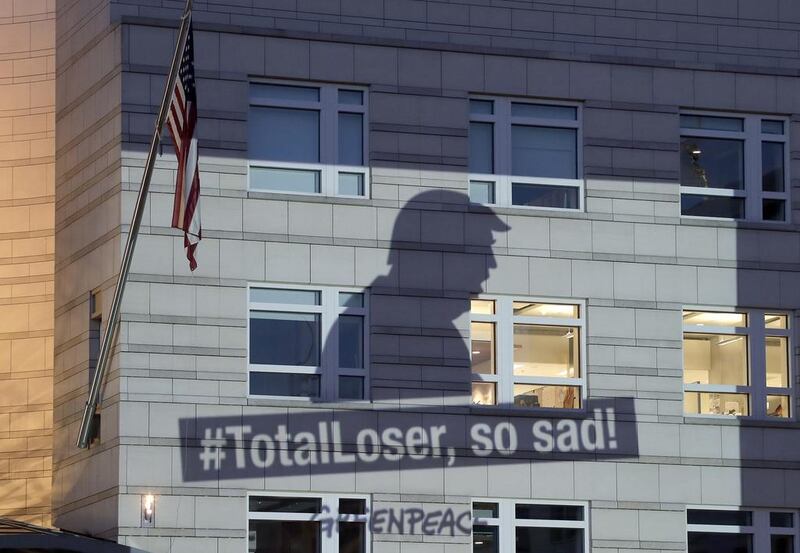A Greenpeace banner showing Donald Trump and the slogan #TotalLoser, so sad! is projected onto the facade of the US embassy in Berlin, Germany, a day after the US president declared he was pulling the US out of the Paris climate change accord / AP