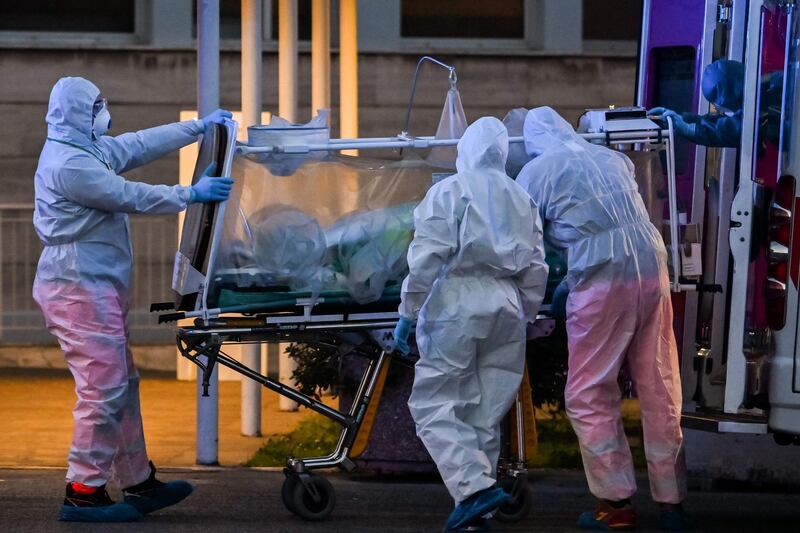 Medical workers in overalls move a patient under intensive care into the newly built Columbus Covid 2 temporary hospital to fight the new coronavirus infection at the Gemelli hospital in Rome.   AFP