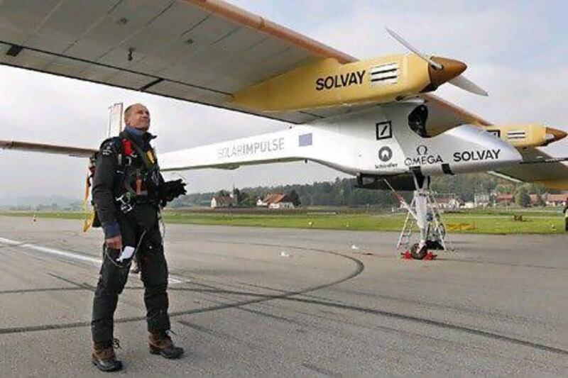 Pilot Bertrand Piccard with the Solar Impulse solar-powered HB-SIA prototype airplane at Payerne airport in Switzerland in October.Pascal Lauener / Reuters