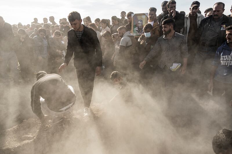 Kurds attend a funeral of people killed in Turkish air strikes in the village of Al Malikiyah, northern Syria. AP