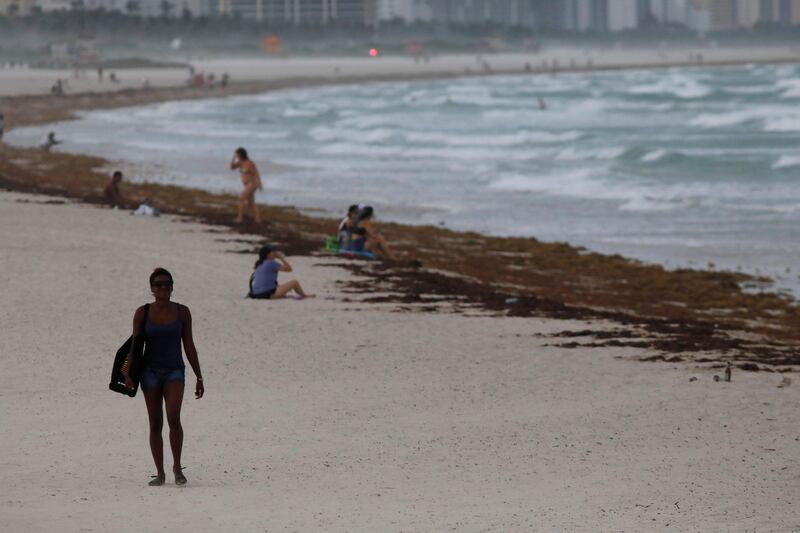 A woman walks along South Beach prior to the arrival of Hurricane Irma to south Florida, in Miami. Carlos Barria / Reuters