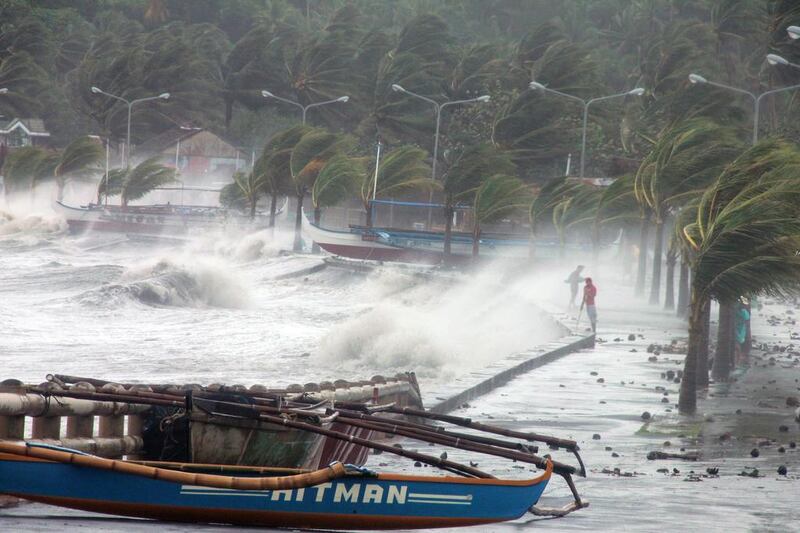 Residents stand along a seawall as high waves pounded them amidst strong winds as Typhoon Haiyan hit the city of Legaspi, Albay province, south of Manila. Charism Sayat / AFP Phoyo