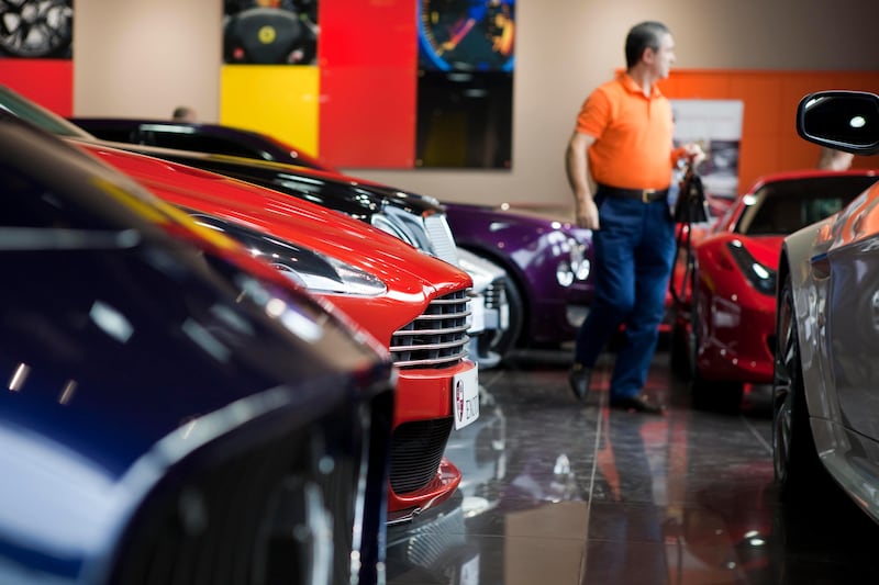 Dubai, United Arab Emirates - January 10 2012 - Customers shop for Rolls Royces, Bentleys, Maseratis, Ferraris and other high end cars sit at the Exotic Cars Showroom off Sheikh Zayed Road. The company was recently featured on Channel 4's "Billionaire Boy Racers" . (Razan Alzayani / The National) 