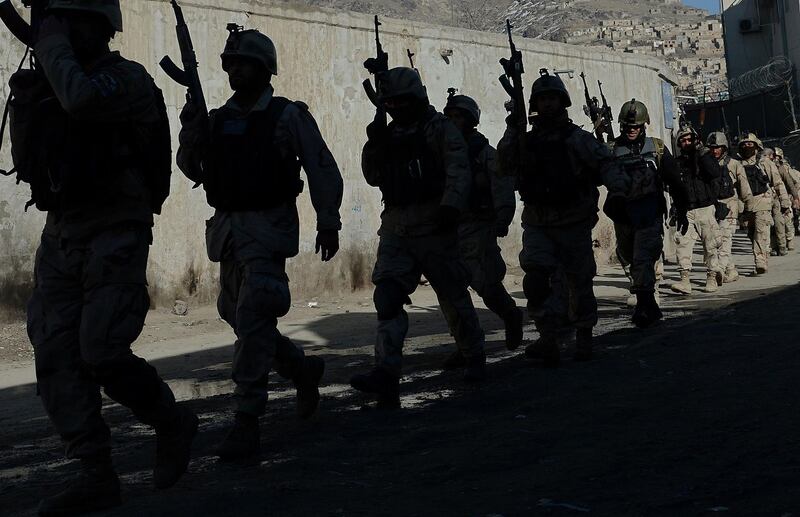 (FILES) In this file photo taken on January 21, 2013 Afghan commandos walk down a road  near the Kabul police headquarters building after a clash between Afghanistan forces and Taliban fighters in Kabul.
Agence France-Presse's chief photographer in Kabul, Shah Marai, was killed April 30, AFP has confirmed, in a secondary explosion targeting a group of journalists who had rushed to the scene of a suicide blast in the Afghan capital. Marai joined AFP as a driver in 1996, the year the Taliban seized power, and began taking pictures on the side, covering stories including the US invasion in 2001. In 2002 he became a full-time photo stringer, rising through the ranks to become chief photographer in the bureau. He leaves behind six children, including a newborn daughter.

  / AFP PHOTO / Shah MARAI