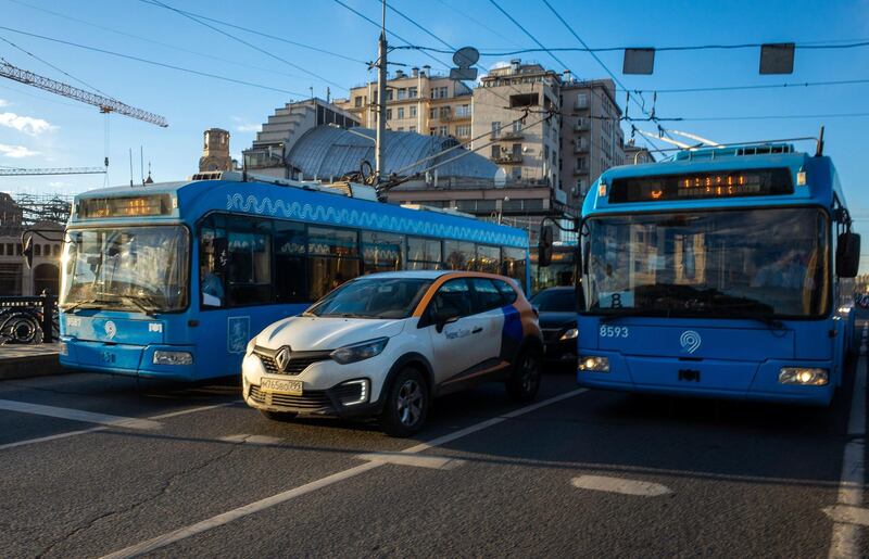 2B7D59F February 19, 2019, Moscow, Russia. Blue regular passenger buses and car of Yandex carsharing company on Maly Kamenny Bridge in Moscow.