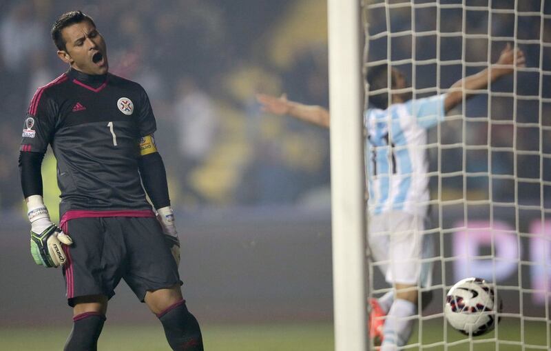 Paraguay goalkeeper Justo Villar reacts after Sergio Aguero, right, scores Argentina's fifth goal in the Copa America semi-final on Tuesday night. Fernando Bizerra Jr / EPA