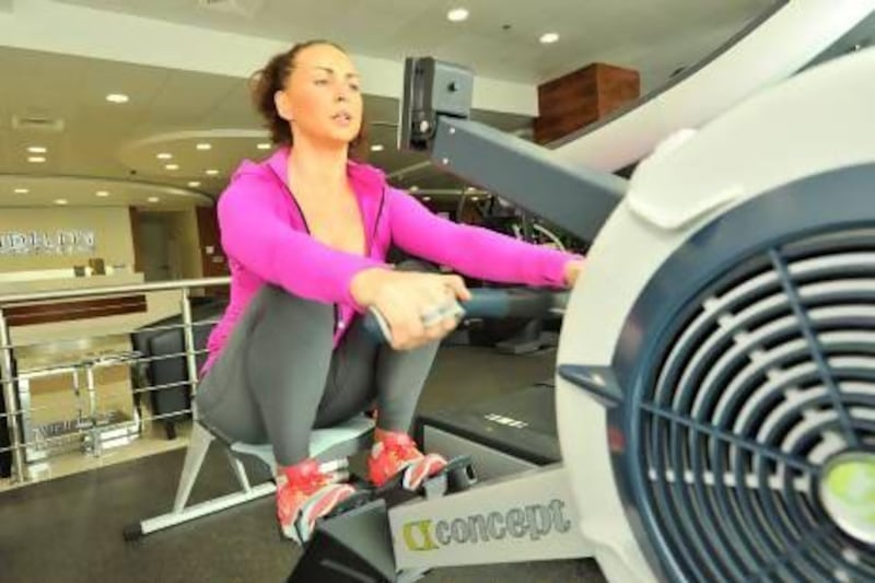Katie Pattison-Hart trains limbers up for an event when she and James Elliot-Square will take to their machines and row for 24 hours. Charles Crowell for The National