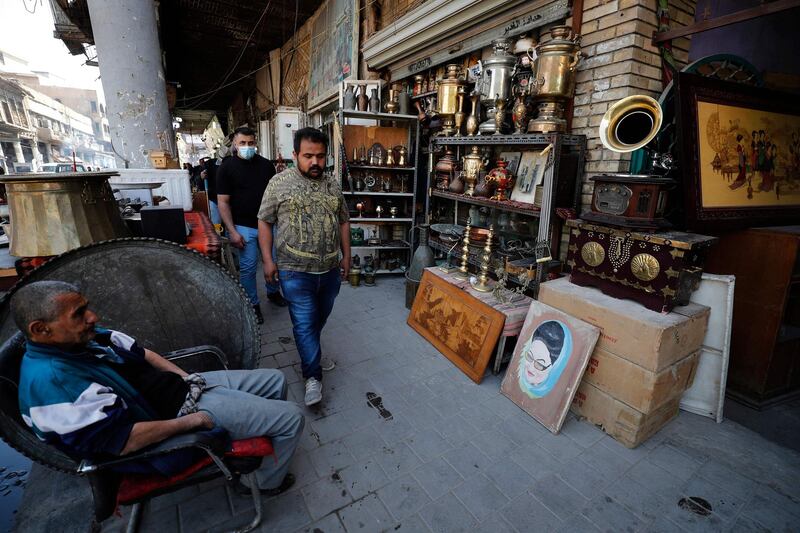 Staff at an antiques shop at Tahrir Square market, Baghdad. AFP