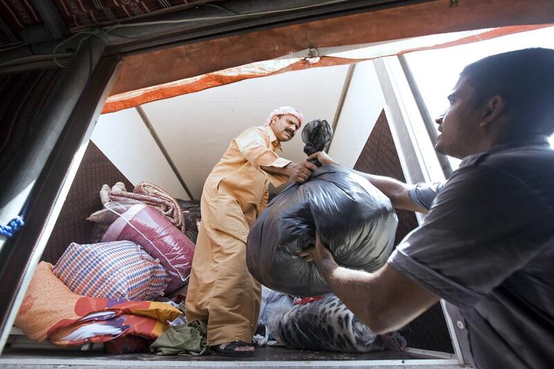 Red Crescent workers load a truck with clothing that will be donated to those in need during Ramadan. Jeff Topping / The National