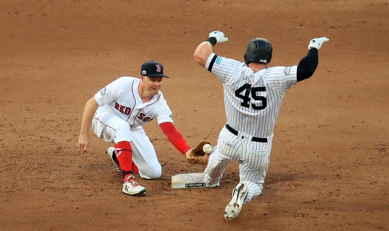 New York Yankees' Luke Voit (right) in action with Boston Red Sox' Brock Holt during the MLB London Series Match at The London Stadium. PRESS ASSOCIATION Photo