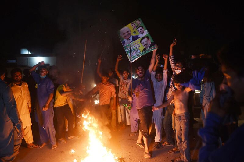 Supporters of former Pakistani Prime Minister Nawaz Sharif burn tyres during a protest ahead of of the arrival of Nawaz from London, in a crally led by Shahbaz Sharif, Nawaz's younger brother and the head of the Pakistan Muslim League-Nawaz (PML-L) party, in Lahore on July 13, 2018.

 Former Pakistan premier Nawaz Sharif was arrested on his return to the country on July 13, 2018, where he faces 10 years in prison for corruption, ahead of already tense elections his party claims are being rigged. / AFP / ARIF ALI
