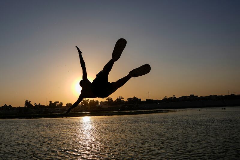 An Iraqi dives into the Tigris to beat the heat in Baghdad. AP