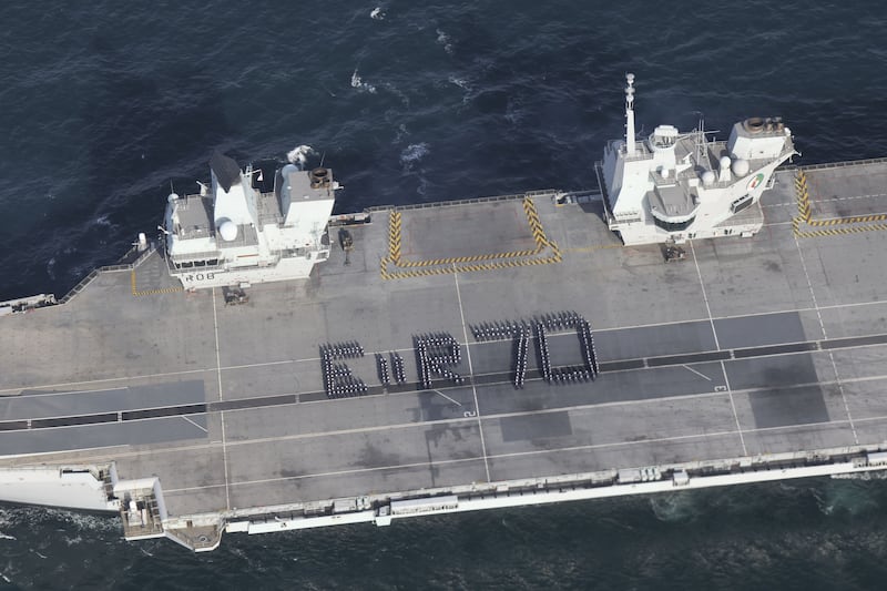 More than 300 Royal Navy sailors spell out a giant platinum jubilee greeting to the Queen from the flight deck of the aircraft carrier 'HMS Queen Elizabeth' on Tuesday. Ministry of Defence / PA