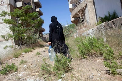 05/07/2013 near Damour, Lebanon: A Syrian mother collects water for cooking. Many of the flats in the vacation-home development lack basics like electricity and running water. Estimates have placed the number of Syrian refugees in Lebanon at well over 500,000 people. *** Local Caption ***  06292013_LM_SyrianRefugees-118.jpg