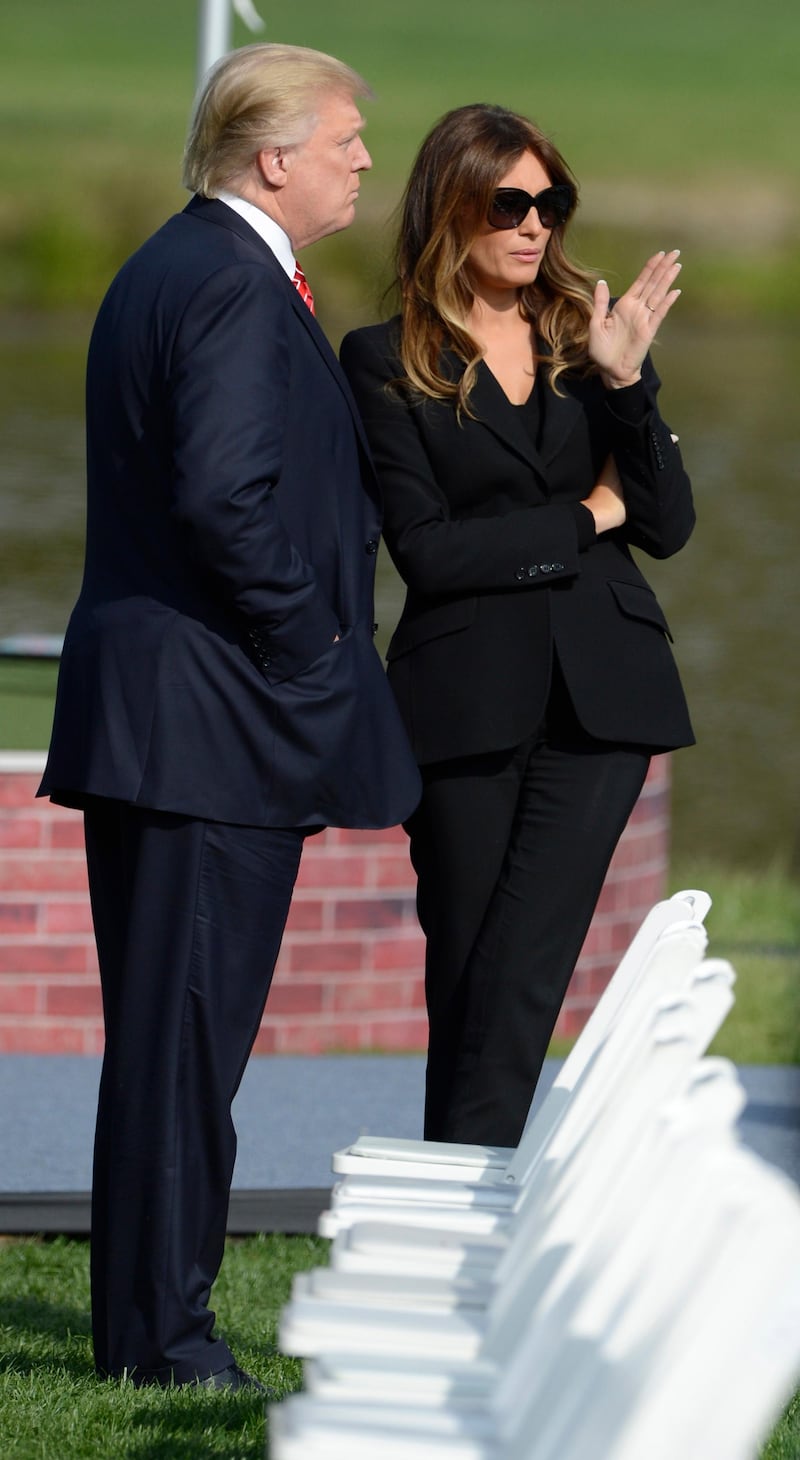 epa03413005 US business mogul Donald Trump and his wife Melania arrive prior to the start of the Opening Ceremony for the 2012 Ryder Cup between Team USA and Team Europe at Medinah Country Club in Medinah, Illinois, USA, 27 September 2012.  The Ryder Cup officially begins 27 September with an opening ceremony and competition begins 28 September.  EPA/ERIK S. LESSER