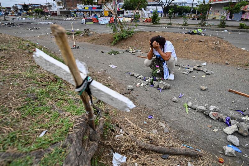 A woman mourns the death of demonstrators during protests against Colombian President Ivan Duque's government, in Cali, Colombia. At least 13 people were killed. AFP