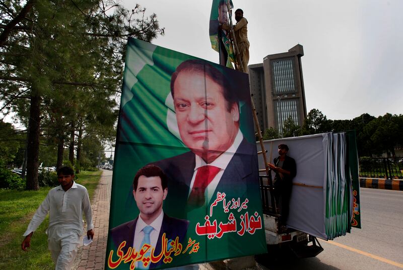 Pakistani workers install a huge billboard of deposed Prime Minister Nawaz Sharif on the planned route of his rally at a highway in Islamabad, Pakistan, Tuesday, Aug. 8, 2017. According to Malik Mohammad Ahmed, a spokesman in Punjab where Lahore is the provincial capital, Sharif planned to travel with a convoy of supporters by road on Wednesday from the capital, Islamabad, to Lahore. (AP Photo/ Anjum Naveed)