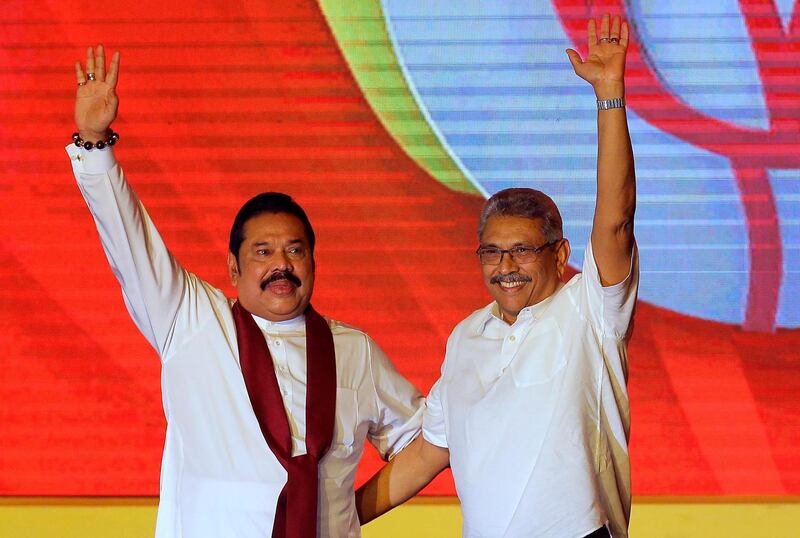 FILE - In this Aug. 11, 2019, file photo, former Sri Lankan President Mahinda Rajapaksa, left, and his brother and former Defense Secretary Gotabaya Rajapaksa wave to supporters during a party convention held to announce the presidential candidacy in Colombo, Sri Lanka. Rajapaksa is credited with helping end the countryâ€™s long civil war and is revered as a hero by the Sinhalese Buddhist majority. He comfortably won Saturdayâ€™s presidential election with about 52% of the ballots. But minorities largely voted for his opponent, fearing Rajapaksa because of allegations of wartime human rights violations against him. (AP Photo/Eranga Jayawardena, File)