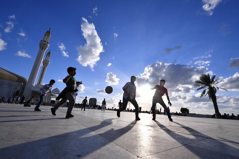 Children play  on the esplanade in front of the Hasan Anani mosque in the Saudi Arabian port city of Jeddah on January 10, 2020. (Photo by GIUSEPPE CACACE / AFP)